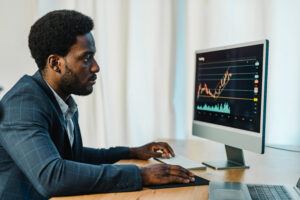 Concentrated black man trading online on binary option